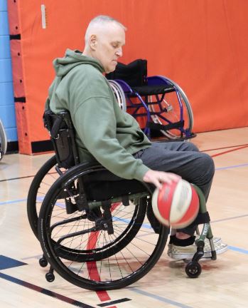 veterans wellness participants trying wheelchair basketball