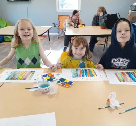 child at table doing art project