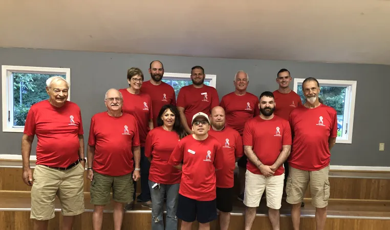 veterans in red shirts group photo